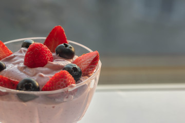 Homemade curd cream with fresh berries on top.