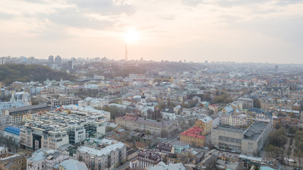 Fototapeta na wymiar The panoramic bird's eye view from drone to the central historical part of Kiev, Ukraine - the Podol district, the district of Dorohozhychi at summer sunset.