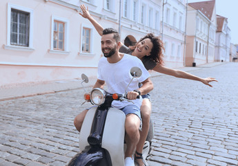 Happy young couple having fun on a scooter © ASDF
