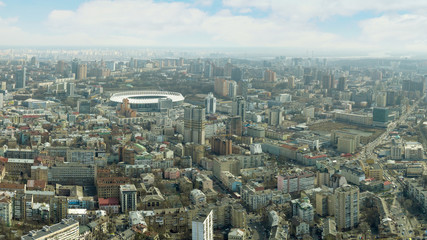 The panoramic bird's eye view shooting from drone to central part of city Kiev, Ukraine with urban infrastructure and residential buildings of at summer sunset.