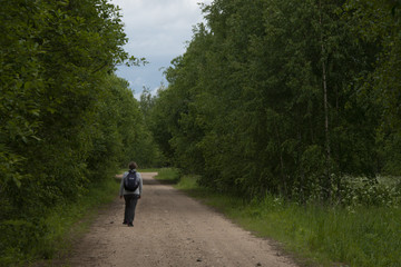 Walk on the country road - with a backpack