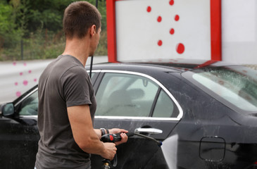 Man washing car outdoors