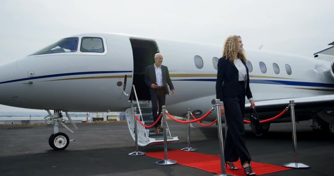 Business people leaving private jet 4k