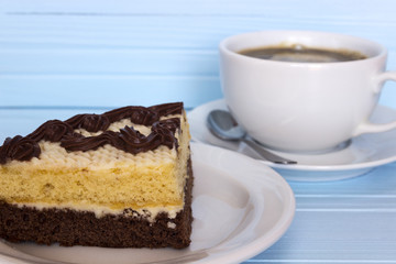 cake and a cup of coffee on a light background