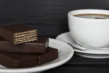 sweets and a cup of coffee on a dark background