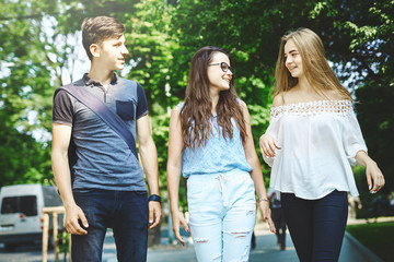 happy friends students perfectly spend time together on a walk in the Park