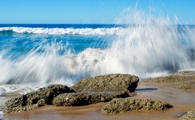 powerful wave crashing on beach