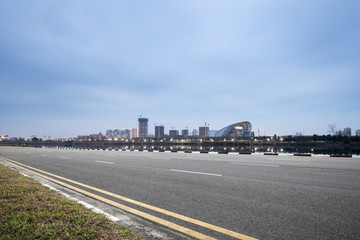 empty asphalt road with modern city skyline