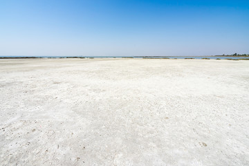 Fototapeta na wymiar Arid landscape of the evaporation pools of Margherita di Savoia salt flats, Apulia, Italy