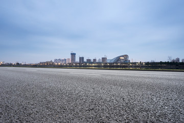 Fototapeta na wymiar empty asphalt road with modern city skyline