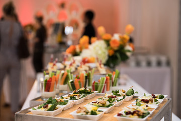 Healthy organic gluten-free delicious green snacks salads on catering table during corporate event...