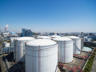 Oil storage tank with oil refinery background