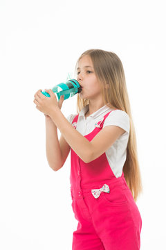 Only clean and fresh water. Girl with water bottle drinking, isolated on white background. Kid girl with long hair drinks. Fresh drink concept. Girl cares about health and refreshing