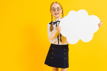 Girl with red pigtails on a yellow background. A charming girl in round transparent glasses is holding a white cloud in her hands.