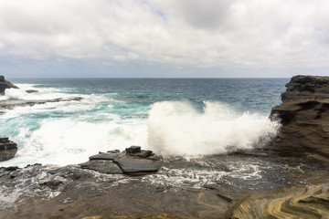 Volcanic shoreline cliffs and turquoise ocean on Oahu, Hawaii