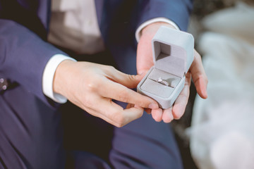 Man open a diamond ring box for marry his girlfriend.