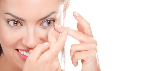 Woman Applying Contact Lens On Her hazel Brown Eyes