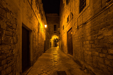 Night view of an alley Trani old town, Apulia, Italy
