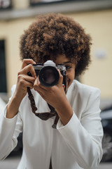 Female Photographer Holding an Old Analog Camera