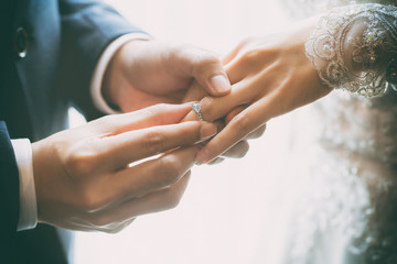 Couple wearing wedding ring at wedding day of them.