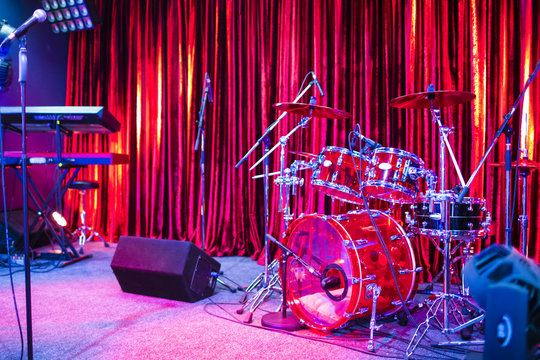 Artist Stage With Drums and Keyboards Sets Along With Microphones Stands and Stage Monitors