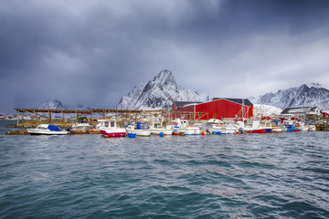 Travelling Concepts. Line of Traditional Norwegian Houses and Fishing Boats at Reine Village on Lofoten Islands.
