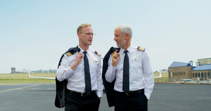 Two male pilots interacting with each other 4k