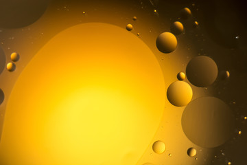 the interaction of water and oil, oil bubbles of various sizes on the water surface, colorful abstract macro background