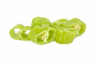portion cut fresh green chili peppers with seeds on white background