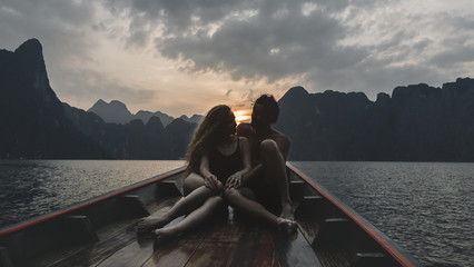 Couple boating on a quiet lake - obrazy, fototapety, plakaty