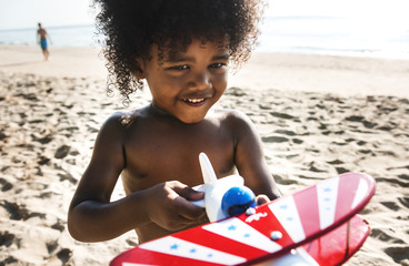 African little boy playing at the beach