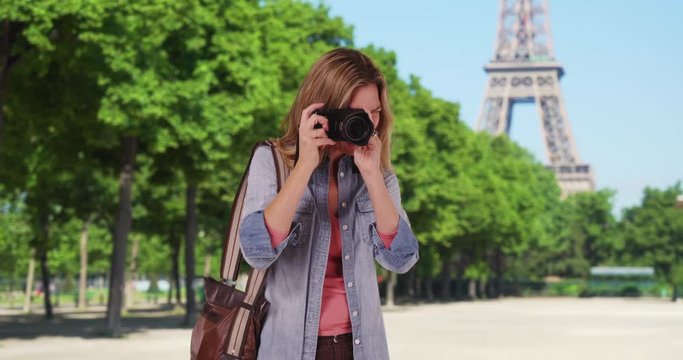 Travel photographer in Paris taking a picture outside smiling, Paris woman tourist taking photograph of summer vacation, 4k
