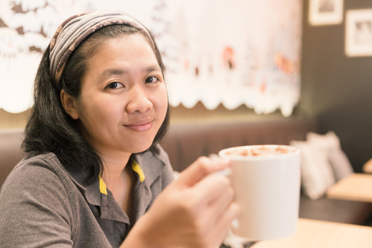 Young woman drink coffee in cafe with vintage tone.