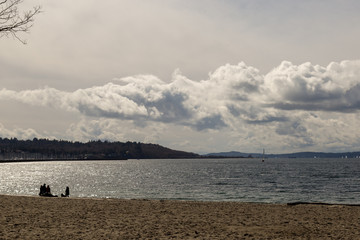 Tourists Enjoying a Beach on a Spring Day