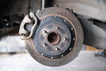 Close up rear disk break in process of new tire replacement and maintenance