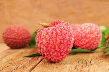 close up red lychee on wood