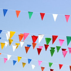 Fototapeta na wymiar colorful triangle flag with sky background