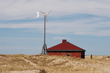 Bright landscape with wine turbine and red brick house © korinoxe