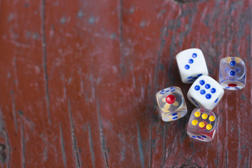 dice on a burgundy wooden background top view, copy space, space for text