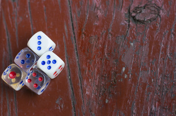 dice on a burgundy wooden background top view