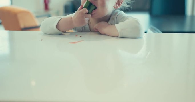 Tilting shot of little boy eating watermelon
