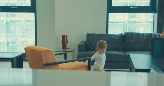 Little toddler boy and mother dancing in city apartment