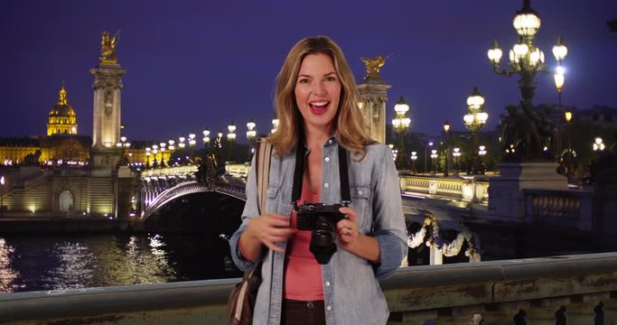 Travel photographer taking pictures of Pont Alexandre III Bridge, Woman tourist with her camera on gorgeous night in Paris, 4k