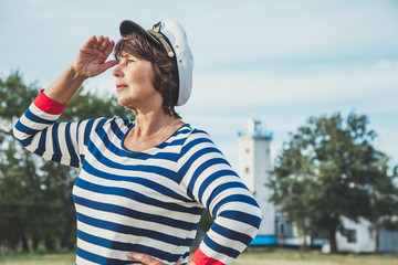 Elderly woman looking into the distance on seashore
