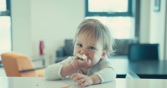 Little boy eating watermelon in city apartment
