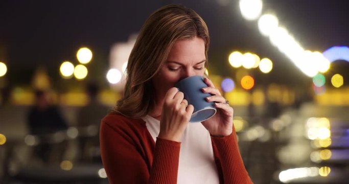 Close up portrait of woman drinking coffee outside at night, Attractive Caucasian woman enjoying coffee, 4k