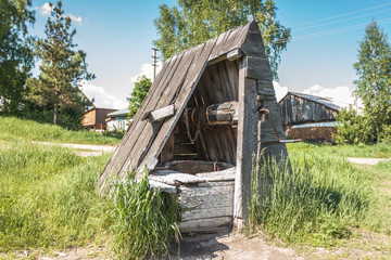 Old abandoned wooden well with beautiful structure in the Siberian village