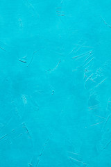 abstract cyan textured dust background. distressed bright blue scratched stucco design. free space concept