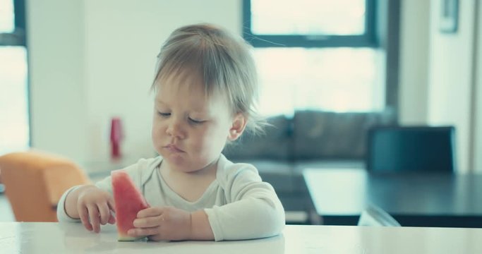Little boy deseeding watermelon