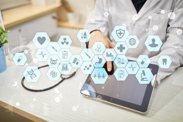 Medical doctor working with modern computer virtual screen interface. Medicine technology and healthcare concept.